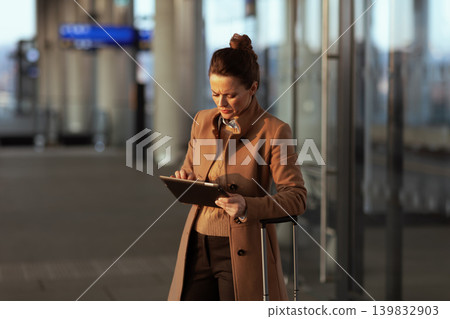 Focused Woman Planning Route on Tablet at Station Focused Woman Planning Route on Tablet at Station 139832903