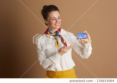 Professional Woman Pointing to a Blue Credit Card Professional Woman Pointing to a Blue Credit Card 139833064