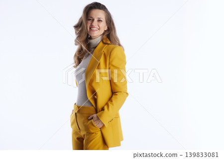Cheerful Businesswoman in Yellow Suit with Hand in Pocket 139833081