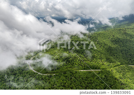 Road trip travel in Appalachian mountains. Car driving on parkway through woods nature in summer wet rainy season. Colorful forest in Tennessee 139833091