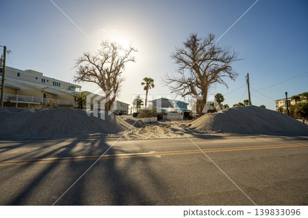 Hurricane Milton aftermath cleanup. Piles of debris and sand on street side on Manasota Key in Florida Hurricane Milton aftermath cleanup. Piles of debris and sand on street side on Manasota Key in Florida 139833096