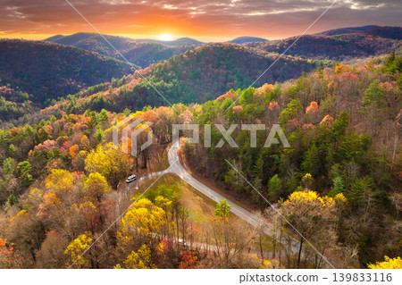 Car driving along mountain road surrounded by colorful autumn trees in Tennessee. Scenic road trip through the Appalachians in fall season Car driving along mountain road surrounded by colorful autumn trees in Tennessee. Scenic road trip through the Appalachians in fall season 139833116