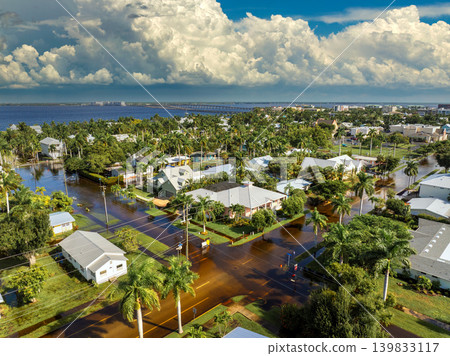 Flooding in Florida caused by tropical storm from hurricane rainfall. Suburb houses in residential community surrounded by flood waters. Aftermath of natural disaster Flooding in Florida caused by tropical storm from hurricane rainfall. Suburb houses in residential community surrounded by flood waters. Aftermath of natural disaster 139833117