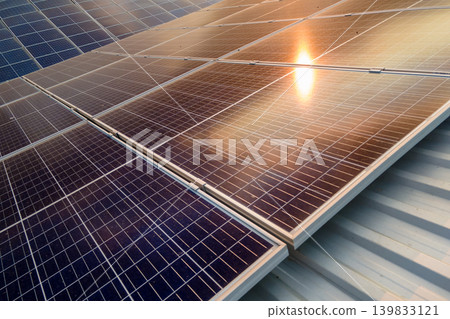 Office building with solar roof. Blue photovoltaic panels for producing clean ecological electric energy. Investing in renewable electricity concept. 139833121