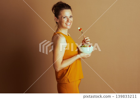 Side Profile of a Woman Enjoying Healthy Salad Side Profile of a Woman Enjoying Healthy Salad 139833211