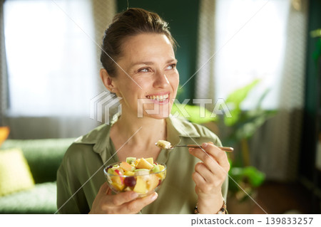 Woman Enjoying Fresh Fruit Salad at Home Woman Enjoying Fresh Fruit Salad at Home 139833257