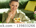 Woman Enjoying a Healthy Fruit Snack on the Couch 139833266