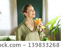 Joyful Woman Starting Her Day with Fresh Juice 139833268