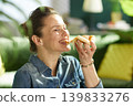 Satisfied Woman Tasting Delicious Cheese Pizza 139833276