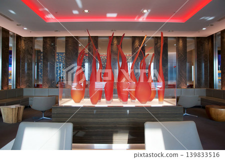 Frankfurt, Germany, 03 November 2017: Glass art installation of flames in a frequent flyer lounge Frankfurt, Germany, 03 November 2017: Glass art installation of flames in a frequent flyer lounge 139833516