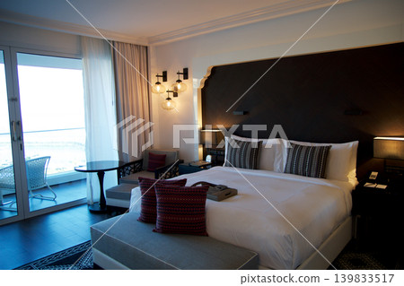 Fujairah, United Arab Emirates, November 04 2017: King Size Bed in Luxury Hotel Room with Sea View Fujairah, United Arab Emirates, November 04 2017: King Size Bed in Luxury Hotel Room with Sea View 139833517