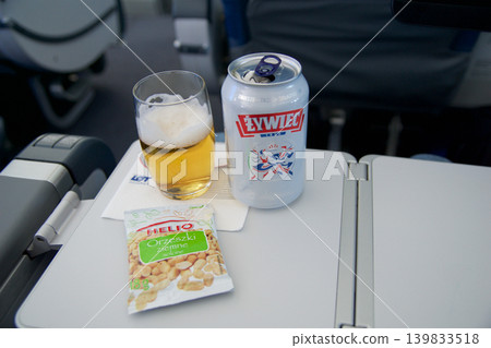 Above the clouds, May 10 2018: Polish beer with peanuts in premium economy class 139833518