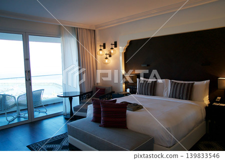 Fujairah, United Arab Emirates, November 04 2017: King Size Bed in Luxury Hotel Room with Sea View Fujairah, United Arab Emirates, November 04 2017: King Size Bed in Luxury Hotel Room with Sea View 139833546