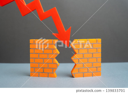 A red arrow breaks down a wall. The crisis destroys the foundations of the economy. The company could not withstand financial pressure and market decline. A red arrow breaks down a wall. The crisis destroys the foundations of the economy. The company could not withstand financial pressure and market decline. 139833701