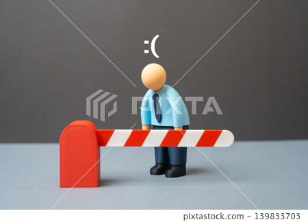 An office worker is sad because the road is blocked by a barrier. Mass layoffs, travel restrictions and limits caused by corporate policy and NDA agreements. An office worker is sad because the road is blocked by a barrier. Mass layoffs, travel restrictions and limits caused by corporate policy and NDA agreements. 139833703