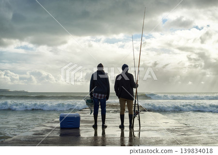 Fishing, fisherman and back of friends on pier by ocean with rod, reel and equipment to catch fish for hobby. Nature, sports and men for bonding, fun and adventure on holiday, vacation and weekend Fishing, fisherman and back of friends on pier by ocean with rod, reel and equipment to catch fish for hobby. Nature, sports and men for bonding, fun and adventure on holiday, vacation and weekend 139834018
