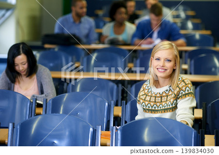 University, students and portrait in lecture, class and learning in hall for education. College, campus and people studying for course in school and writing notes for project, research or knowledge University, students and portrait in lecture, class and learning in hall for education. College, campus and people studying for course in school and writing notes for project, research or knowledge 139834030