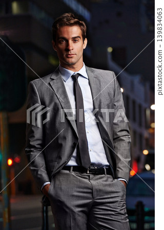 Fashion, night and portrait of businessman in city for commute, travel from office and style. Professional, corporate worker and person in urban town for entrepreneurship, job and career in London Fashion, night and portrait of businessman in city for commute, travel from office and style. Professional, corporate worker and person in urban town for entrepreneurship, job and career in London 139834063