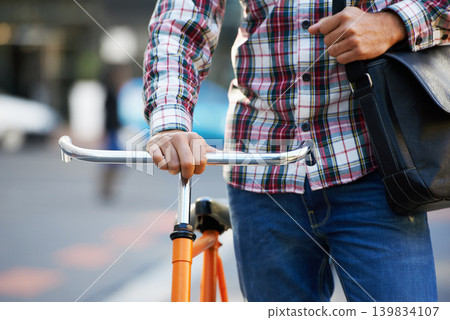 Hands, person and push bike in street to travel on eco friendly transport outdoor, commute or walking on trip. Cycling, bag and bicycle in urban town, city or road for journey or closeup in summer Hands, person and push bike in street to travel on eco friendly transport outdoor, commute or walking on trip. Cycling, bag and bicycle in urban town, city or road for journey or closeup in summer 139834107