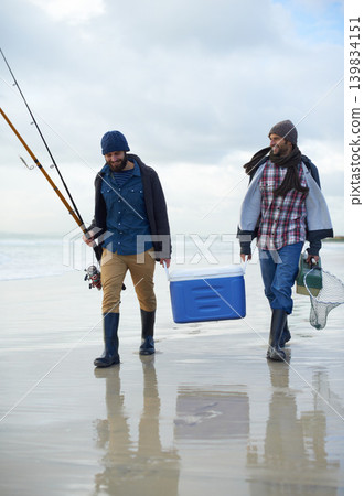 Waves, fishing and men walking on beach together with cooler, tackle box and holiday conversation. Ocean, fisherman and friends with rods, bait and tools in nature on winter morning vacation at sea. 139834151