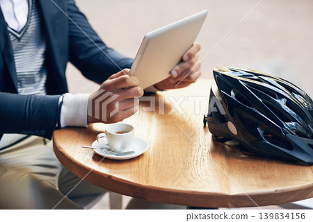 Businessman, hands and outdoor at cafe with tablet for reading news, article or travel research. Online, communication and cyclist with tech for social media, networking and scroll blog on website Businessman, hands and outdoor at cafe with tablet for reading news, article or travel research. Online, communication and cyclist with tech for social media, networking and scroll blog on website 139834156