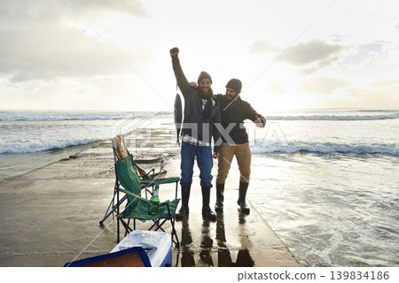 Happy, portrait and people fishing at ocean with pride for tuna catch on pier at sunset. Fisherman, friends and smile holding fish in hand with success in nature at sea on holiday or vacation Happy, portrait and people fishing at ocean with pride for tuna catch on pier at sunset. Fisherman, friends and smile holding fish in hand with success in nature at sea on holiday or vacation 139834186