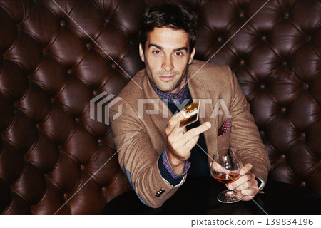 Portrait, credit card and man with alcohol for payment, purchase and sales at club. Face, drinking and person buying whiskey, scotch and customer with brandy at pub in glass at vintage bar at night Portrait, credit card and man with alcohol for payment, purchase and sales at club. Face, drinking and person buying whiskey, scotch and customer with brandy at pub in glass at vintage bar at night 139834196