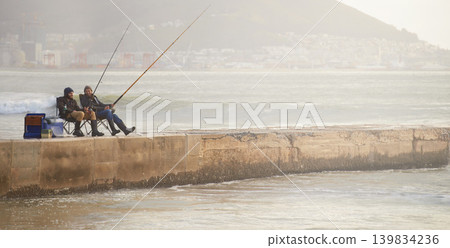 Friends, men and fishing on pier in nature with rod, water and relax on vacation, holiday and travel. Friendship, people and bonding in morning with overcast, sky and beach for activity and hobby Friends, men and fishing on pier in nature with rod, water and relax on vacation, holiday and travel. Friendship, people and bonding in morning with overcast, sky and beach for activity and hobby 139834236
