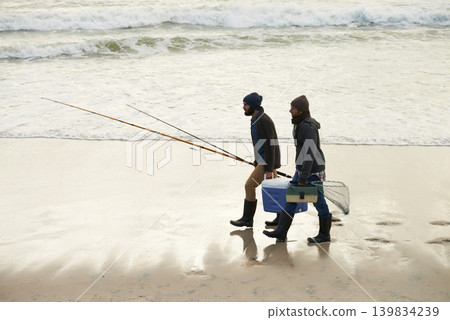Calm, fishing and men walking on beach together with cooler, tackle box and holiday conversation. Ocean, fisherman and friends with rods, bait and tools at waves on winter morning vacation at sea. 139834239