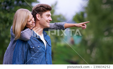 Couple, smile and happiness with pointing finger in park, outdoor setting and bonding with activities. Relationship, goals and romance with fun day in forest for lifestyle, wellness and relax Couple, smile and happiness with pointing finger in park, outdoor setting and bonding with activities. Relationship, goals and romance with fun day in forest for lifestyle, wellness and relax 139834252