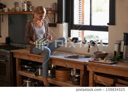 Happy, woman and eating salad in home kitchen, nutrition and fresh leafy greens for healthy diet. Vegetables, bowl and hungry person with fork for food, lunch and organic vegan meal for wellness Happy, woman and eating salad in home kitchen, nutrition and fresh leafy greens for healthy diet. Vegetables, bowl and hungry person with fork for food, lunch and organic vegan meal for wellness 139834325