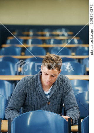 Writing, college and man student in classroom brainstorming for exam studying ideas. Planning, education and young male person in lecture hall with question for university assignment at academy. Writing, college and man student in classroom brainstorming for exam studying ideas. Planning, education and young male person in lecture hall with question for university assignment at academy. 139834378