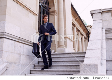 Business, briefcase and man walking on steps outside law firm in city with evening commute, sidewalk and court building. Businessman, lawyer or attorney on outdoor stairs with bag for urban travel. 139834387