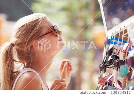 Woman, buying sunglasses and shopping at market outdoor in summer with consumer at flea store. Sales, person and purchase shades at shop, decision and retail choice of customer trying eyewear gift 139834512