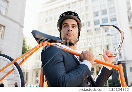 Businessman, holding bicycle and helmet in city for travel, commute or journey to work in Chicago. Male person, buildings and road bike for sustainability, eco friendly and mobility in morning 139834523