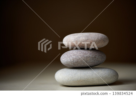 Pile, studio or stones at spa for healing, massage or wellness treatment therapy for balance. Stack, aromatherapy and rocks for a calm, zen or peace atmosphere at a natural salon on black background Pile, studio or stones at spa for healing, massage or wellness treatment therapy for balance. Stack, aromatherapy and rocks for a calm, zen or peace atmosphere at a natural salon on black background 139834524