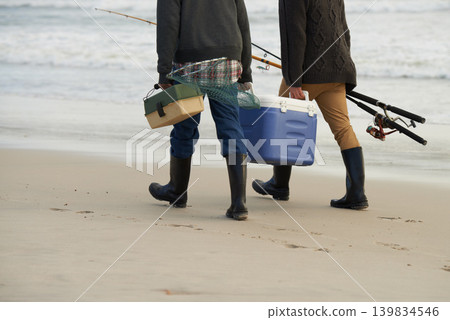 Walk, fishing and men on beach together with cooler, tackle box and holiday adventure. Ocean, fisherman and friends with rods, bait and tools for hobby at waves on winter morning vacation at sea. Walk, fishing and men on beach together with cooler, tackle box and holiday adventure. Ocean, fisherman and friends with rods, bait and tools for hobby at waves on winter morning vacation at sea. 139834546