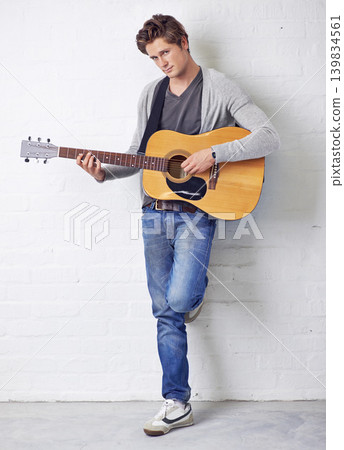 Man in portrait, guitar and musician with creativity and music, acoustic for entertainment and performance on wall background. Busker, artist and musical instrument for art, track or song with talent Man in portrait, guitar and musician with creativity and music, acoustic for entertainment and performance on wall background. Busker, artist and musical instrument for art, track or song with talent 139834561