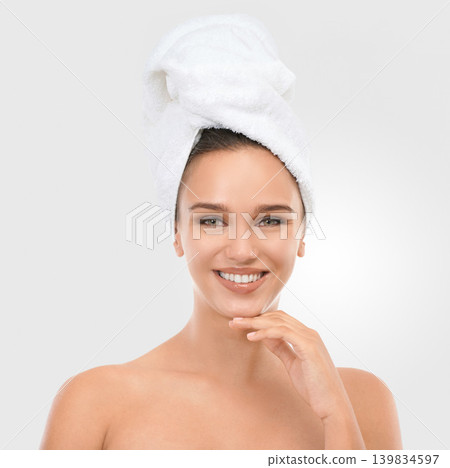 Portrait, woman and smile with head towel for skincare, wellness and beauty on light grey background. Happy, female person and laugh with glow for self care, dermatology and spa treatment with mockup Portrait, woman and smile with head towel for skincare, wellness and beauty on light grey background. Happy, female person and laugh with glow for self care, dermatology and spa treatment with mockup 139834597