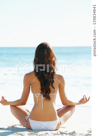 Woman, meditation and zen on beach for spiritual wellness, awareness or yoga in nature. Rear view of female person or yogi meditating for inner peace, breathing or health by ocean coast on mockup Woman, meditation and zen on beach for spiritual wellness, awareness or yoga in nature. Rear view of female person or yogi meditating for inner peace, breathing or health by ocean coast on mockup 139834641