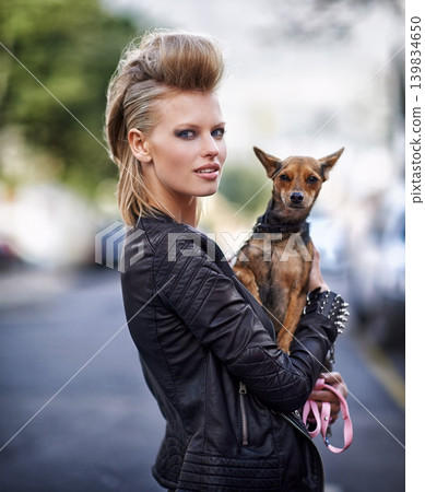 Woman, portrait and leather jacket with dog, happy and rock n roll for unique in punk fashion and city for pet chihuahua. London, person and face in funky clothes in town and care for domestic animal Woman, portrait and leather jacket with dog, happy and rock n roll for unique in punk fashion and city for pet chihuahua. London, person and face in funky clothes in town and care for domestic animal 139834650