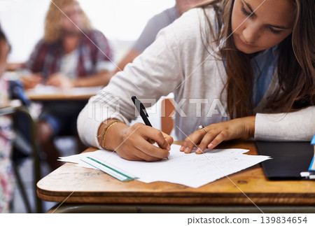 University, classroom and woman writing exam at desk for education, knowledge and opportunity. College, learning and student with paper for test, assessment and studying with books, notes or report. University, classroom and woman writing exam at desk for education, knowledge and opportunity. College, learning and student with paper for test, assessment and studying with books, notes or report. 139834654