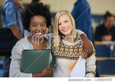 Portrait, university and women students in classroom with text books and documents for information. Smile, happy and female friends embracing, standing and bonding together in lecture hall at academy 139834767