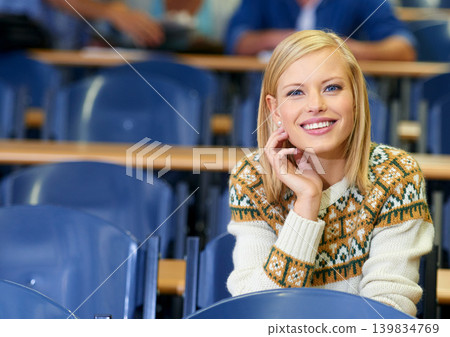 Happy, student and learning in class at university, lecture and listening to professor in education hall. College, campus and smile for studying course in school for project, research or knowledge 139834769