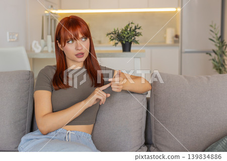 Young woman counts tasks on fingers folds digits tallies list with focus and nods thoughtful rhythm 139834886