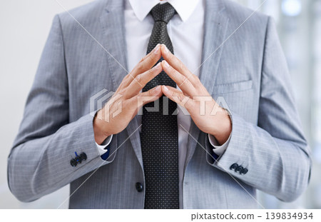Hands in front of chest, business and man with confidence, closeup and suspicious in workplace. Person, employee or consultant in suit, gesture or deception with fraud or idea with feedback or review Hands in front of chest, business and man with confidence, closeup and suspicious in workplace. Person, employee or consultant in suit, gesture or deception with fraud or idea with feedback or review 139834934