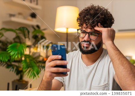 Arabian man reacts to bad news on smartphone losing online game lottery jackpot at night very upset Arabian man reacts to bad news on smartphone losing online game lottery jackpot at night very upset 139835071