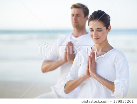 Couple, yoga and ocean with meditation, peace and sitting on sand in morning with mindfulness in summer. Man, woman and outdoor for namaste with spiritual growth, balance or zen at beach in Cape Town Couple, yoga and ocean with meditation, peace and sitting on sand in morning with mindfulness in summer. Man, woman and outdoor for namaste with spiritual growth, balance or zen at beach in Cape Town 139835201