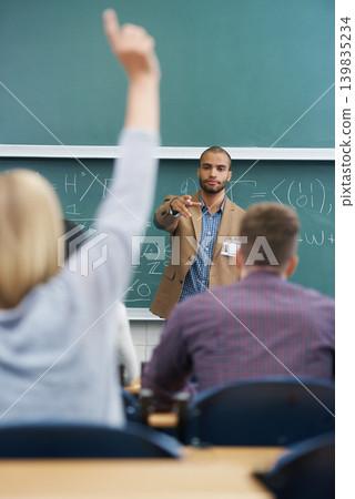 Teacher, students and question in lecture hall, university and professor with information and feedback. People, education and college with knowledge and learning with answer and ideas with solution Teacher, students and question in lecture hall, university and professor with information and feedback. People, education and college with knowledge and learning with answer and ideas with solution 139835234