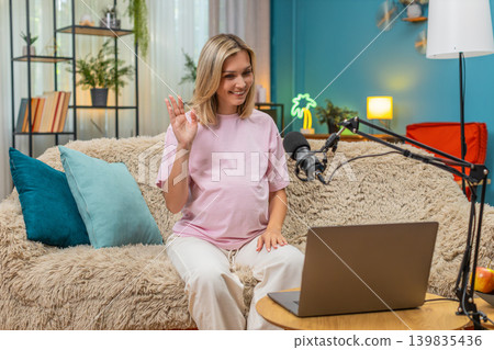 Pregnant woman hosting live webinar laptop studio mic giving prenatal guidance teaching moms support Pregnant woman hosting live webinar laptop studio mic giving prenatal guidance teaching moms support 139835436